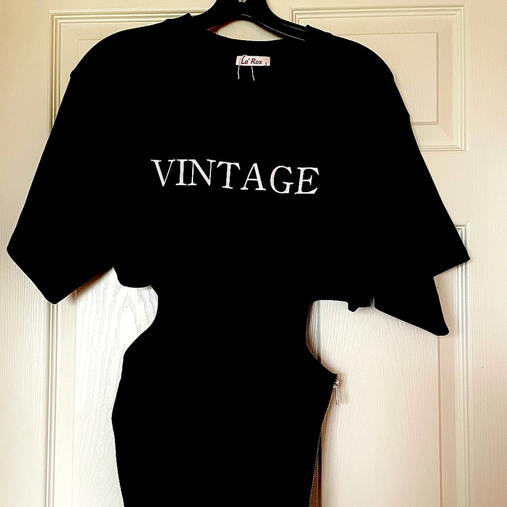 Black top with cut out sides. Size large. Never worn.Smoke free home.No pets.